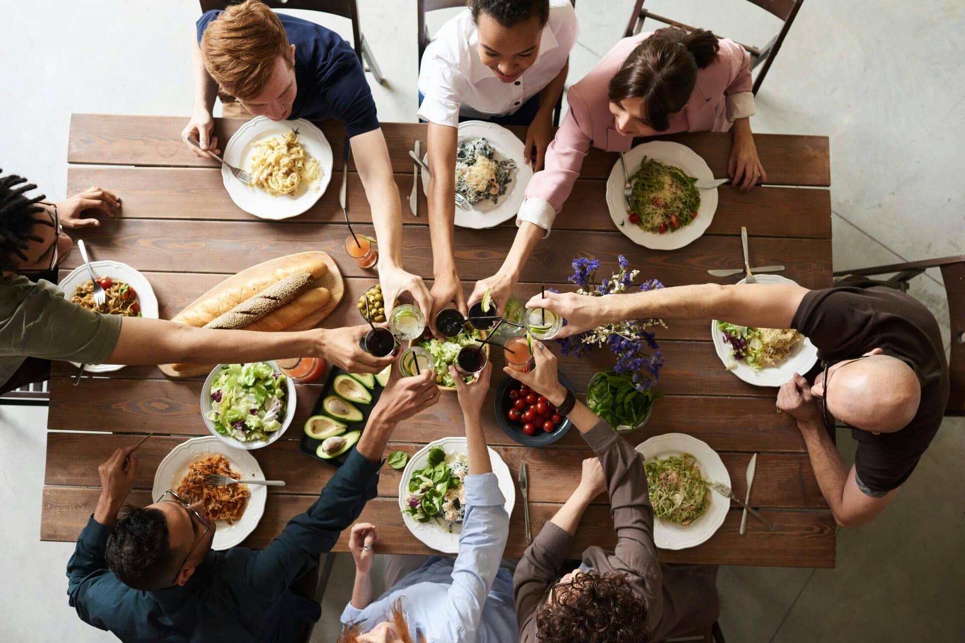 a family sitting at a table giving a cheers